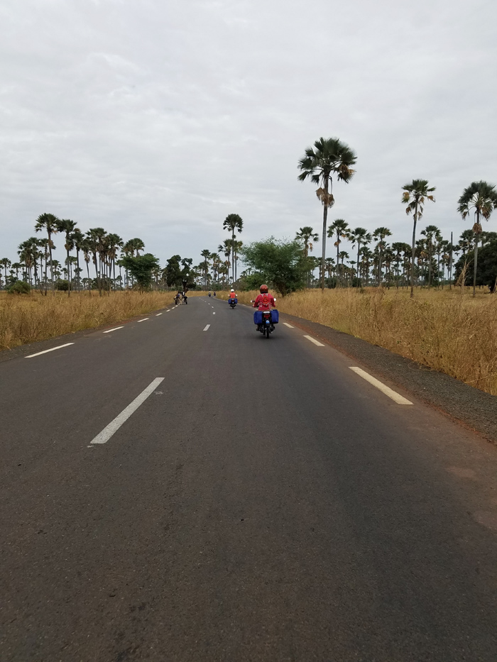 riding a scooter through the Sine-Saloum of Senegal